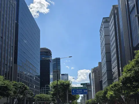 Office towers along the main road near Gangnam station on a clear day